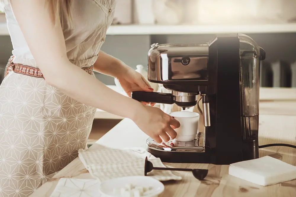 woman-making-fresh-espresso-coffee-maker