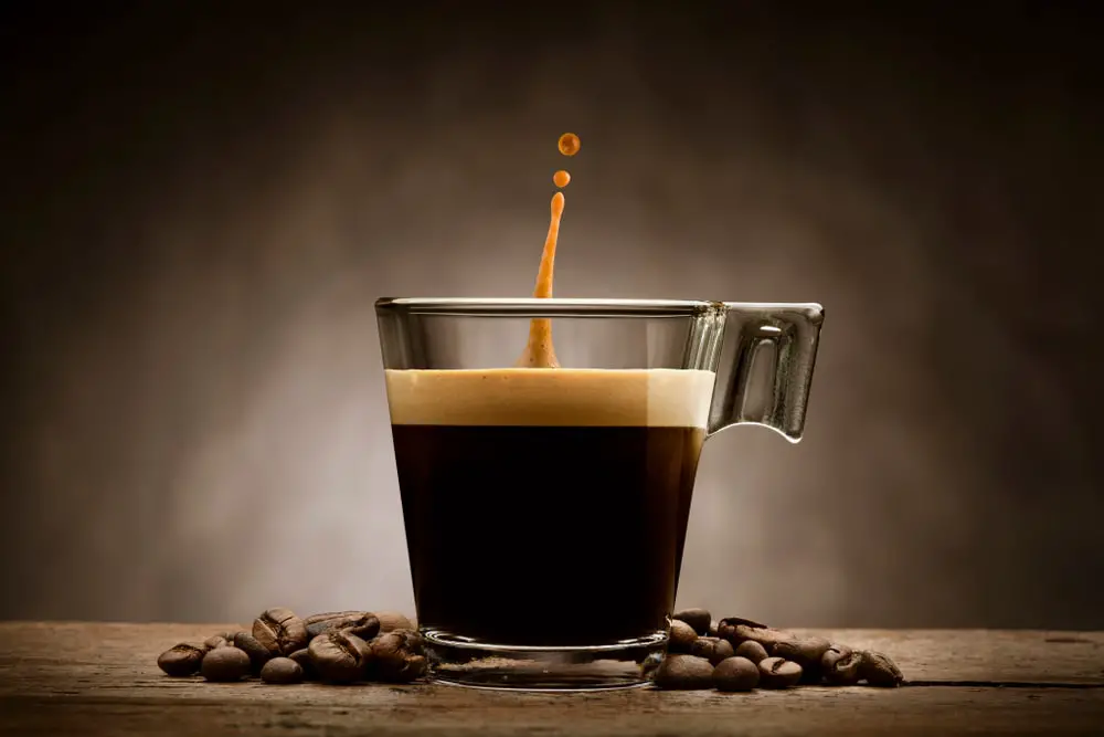 black-coffee-glass-cup-beans-jumping