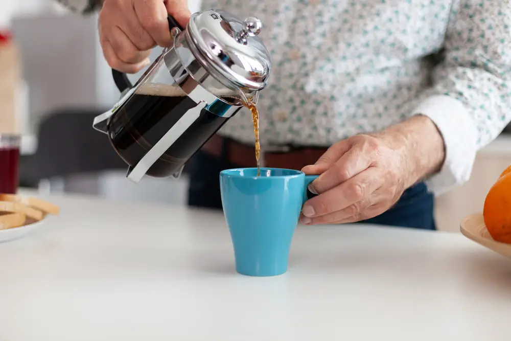 close-senior-man-pouring-hot-coffee