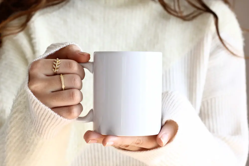 girl-white-sweater-holding-coffee-mug