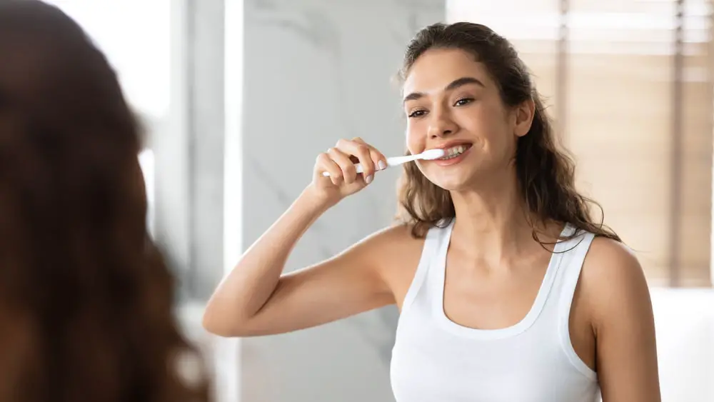 happy-lady-brushing-teeth-toothbrush-standing