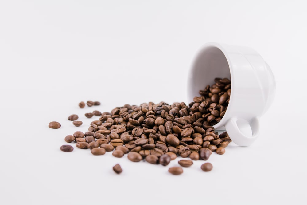white-cup-coffee-sprinkled-beans