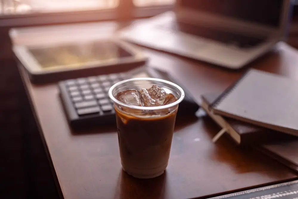 ice-coffee-on-office-workplace-laptop