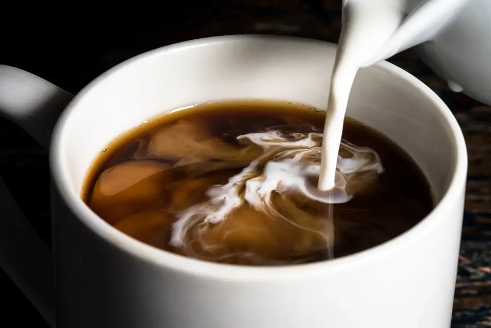pouring-cream-into-cup-coffee