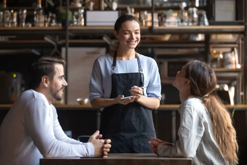 smiling-waitress-wear-apron-hold-notepad