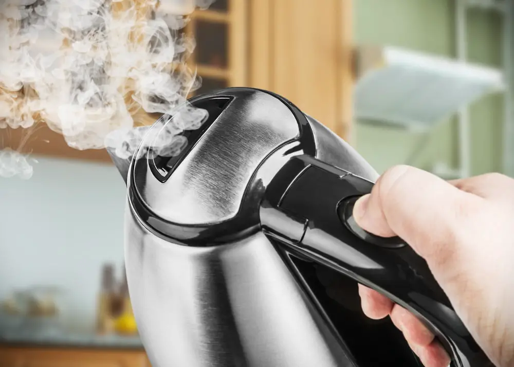 stainless-steel-electric-kettle-hand-on