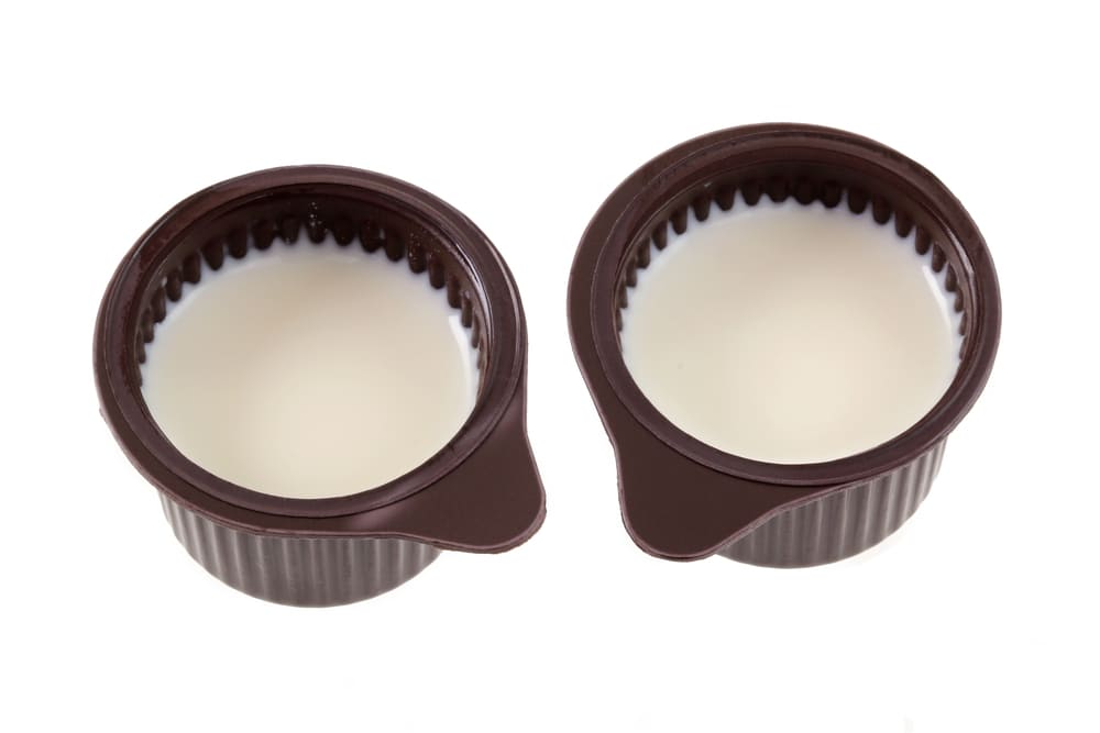two-small-cup-coffee-creamer-isolated
