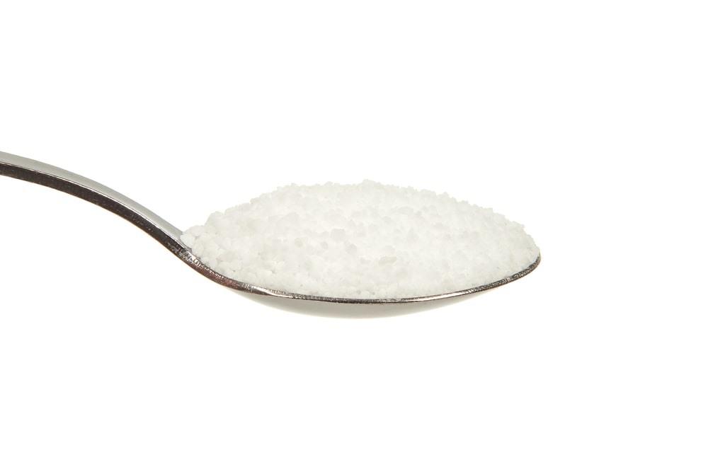 salt-on-teaspoon-white-background