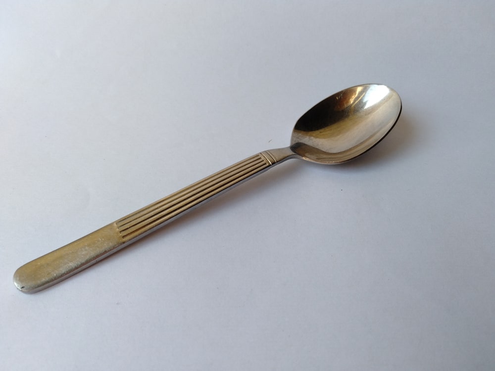 shiny teaspoon closeup white background