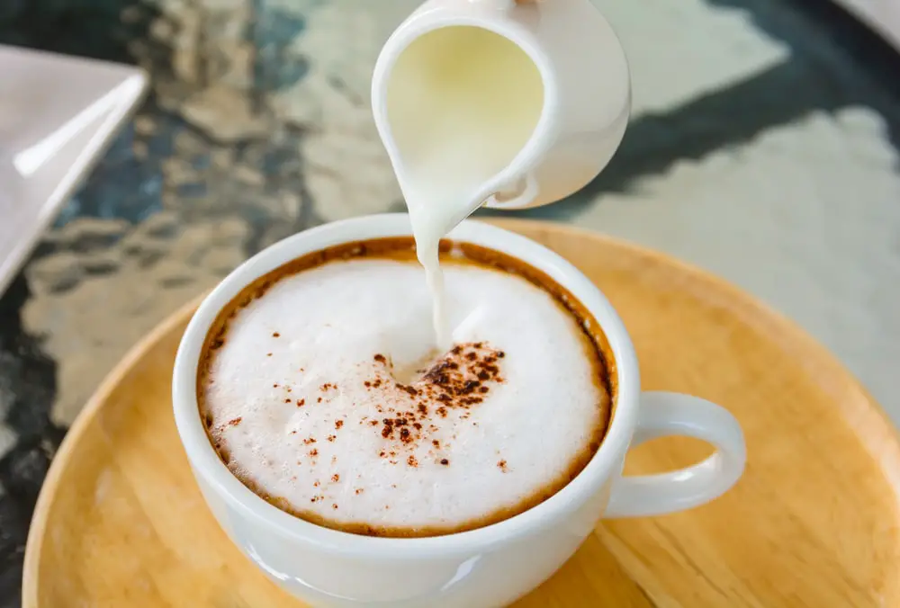 pouring-cream-into-cup-hot-coffee