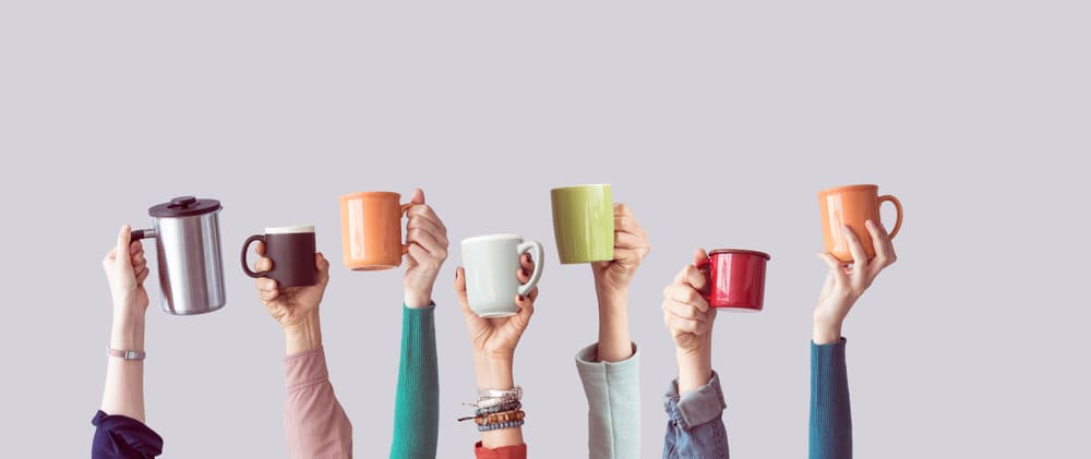 many-different-arms-raised-holding-coffee