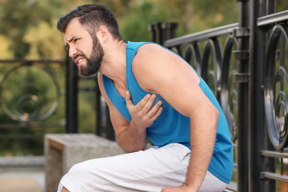 young-man-suffering-heart-attack-outdoors